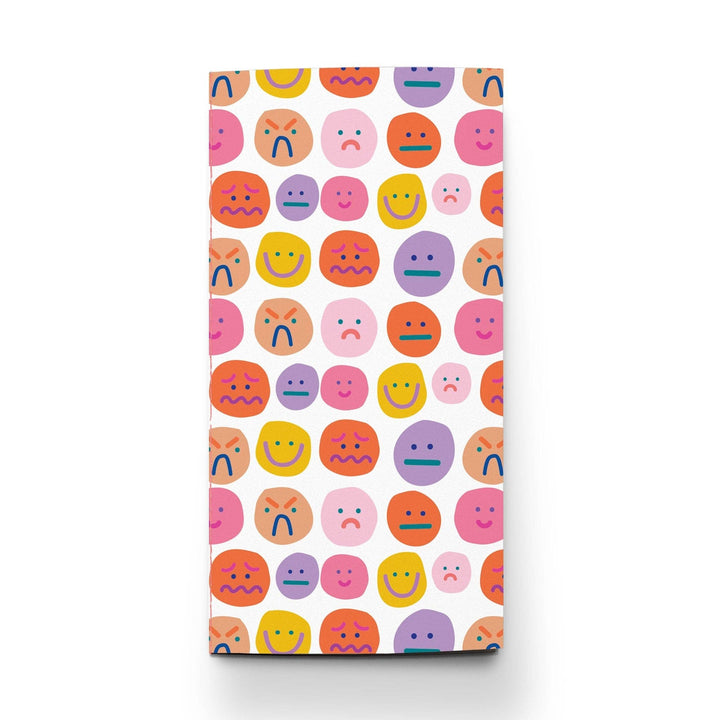 Cover of notebook with colorful faces in a variety of expressions pattern.