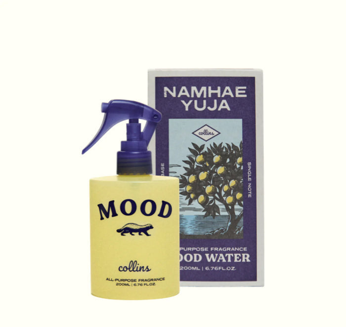Yellow bottle with a purple pump and text, next to its box with an illustration of a Yuja tree with yellow fruit.