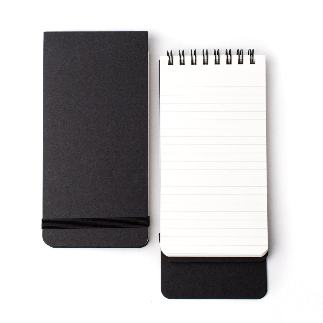 Closed and open ruled spiral-bound notepads, black