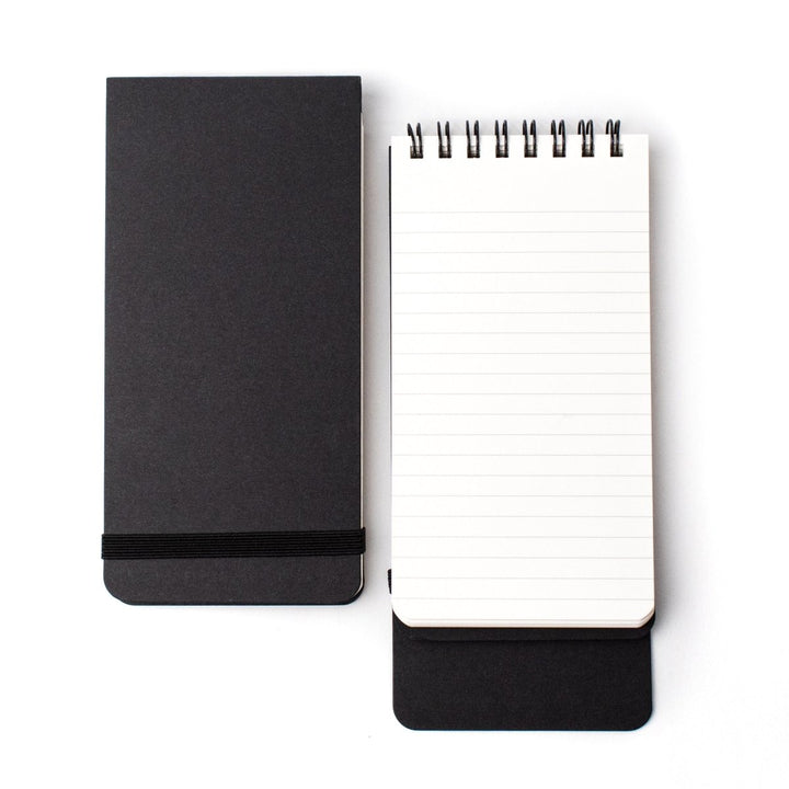 Closed and open ruled spiral-bound notepads, black