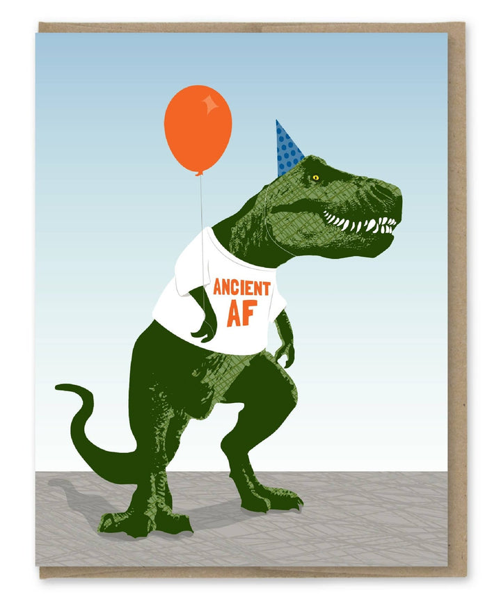 Green tyrannosaurus rex wearing party hat and t-shirt reading "Ancient AF" and holding an orange balloon