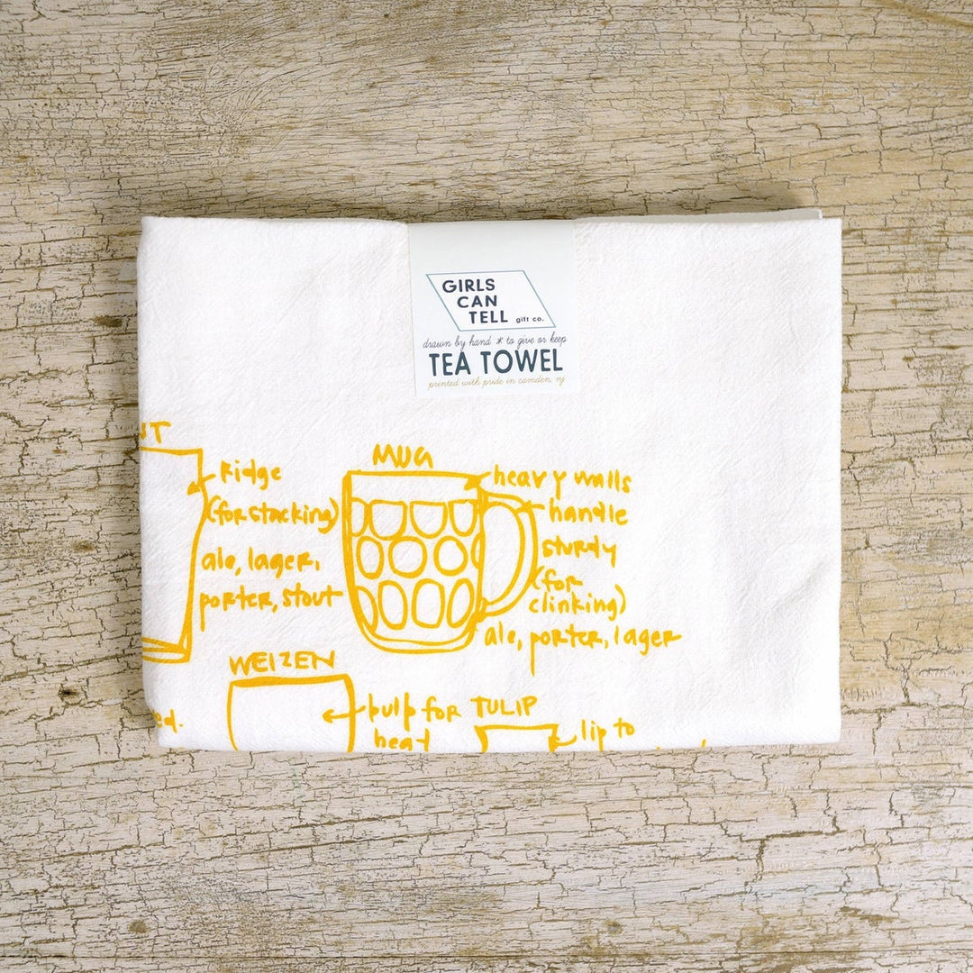 100 percent cotton kitchen towel with a variety of beer glasses hand drawn in yellow ink, with helpful text.