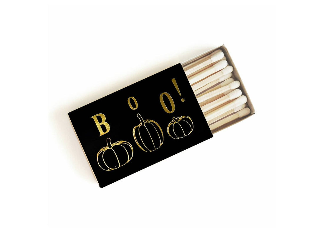 Black matchbox with image etched in gold. White-tipped matches.