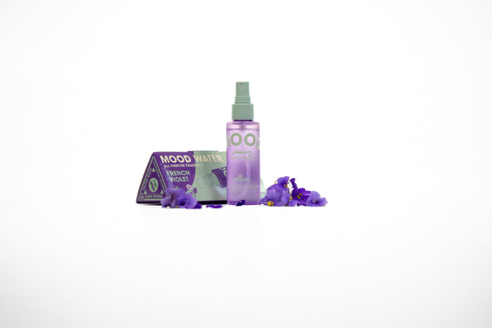 purple and aqua box with spray bottle and lavender blossoms next to it
