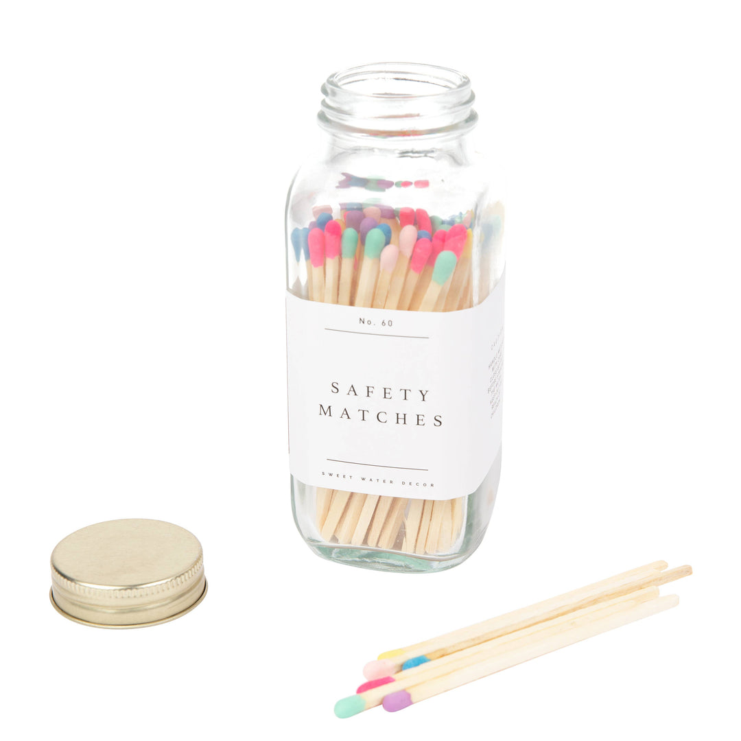 Clear jar of safety matches with different colored tips. abel says Safety Matches.