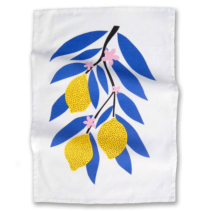 Bright lemons on a stalk with blue leaves and pink flowers on a white cotton kitchen towlel.