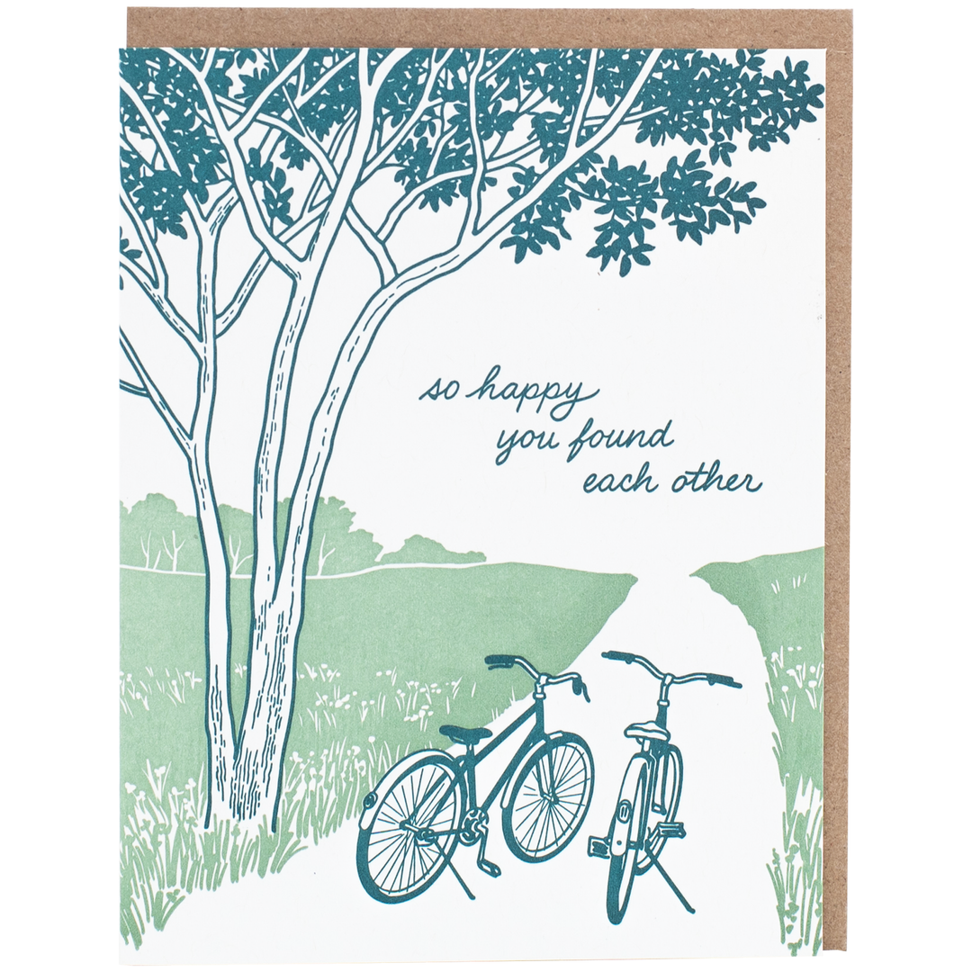 Greeting card with pen and ink drawing of two bicycles beside a tree on a meadow path 