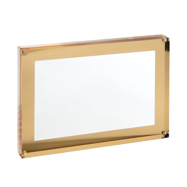 Gold rimmed picture frame with a small magnet in each corner.