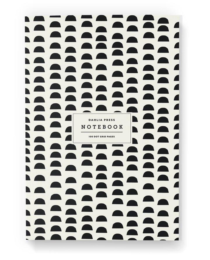 Notebook cover with black half circles on a white background