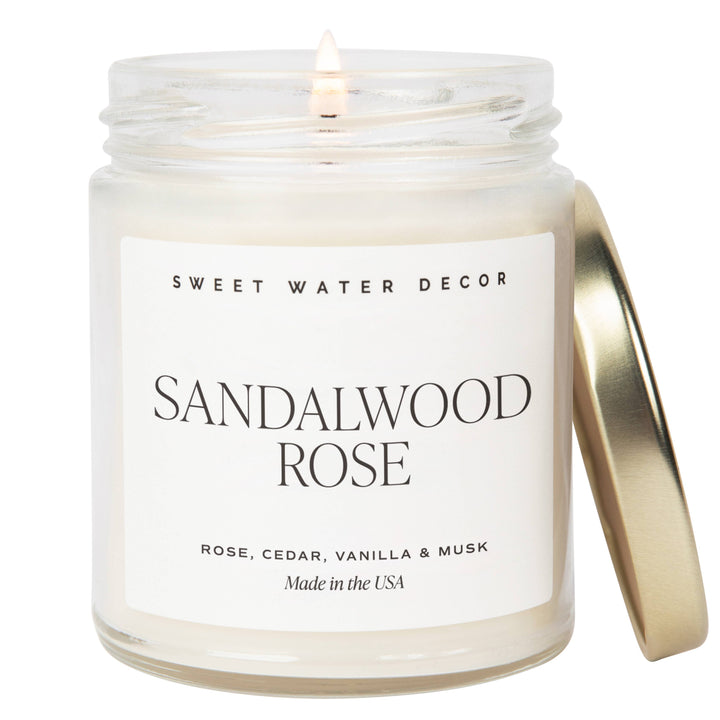 Scented soy candle in a clear glass container with metal lid. Label is Sandalwood Rose Rose / Cedar / Vanilla / Musk